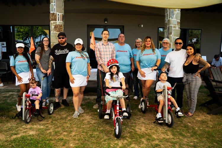 Event coverage photo of Lakeside AMBUCS volunteers and golfers supporting mobility and independence at the charity golf tournament.